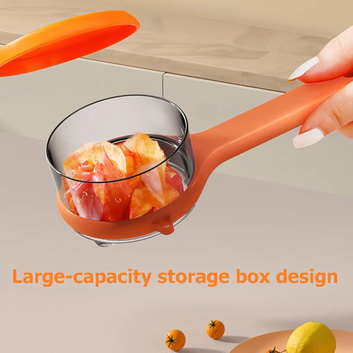 A hand holds the Double-Sided Stainless Steel Peeler with Storage Box – a multi-functional fruit & vegetable peeler featuring a transparent, large-capacity storage container; fruit and a countertop appear in the background.